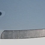 Close-up view of the Double Wall Fabric, Drop Stitch Tarpaulin's surface, showing a valve and a transparent rectangular window on a light gray textured background.