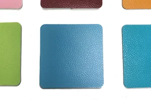 A blue textured square sample of PVC Floor Vinyl is centered between green and turquoise squares against a white background.