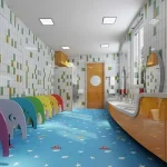 A brightly lit children's bathroom featuring colorful elephant-shaped stalls, multiple sinks, and tiled walls. The floor, covered with PVC Floor Vinyl in blue, is adorned with small white starfish and other ocean-themed designs.