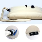 Beige pillow water tank with metal pads in the corners, featuring a collapsible design, a blue valve, and connection points. Two close-up insets showcase the valve and a bolted attachment on the bladder.